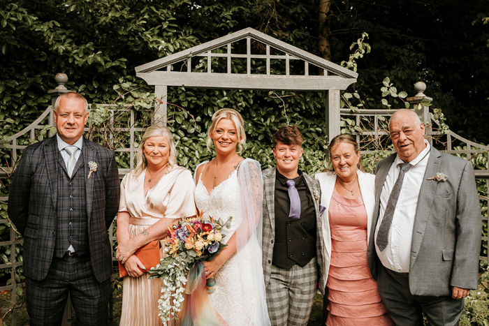 Brides smile with their parents