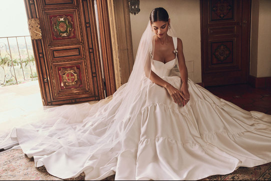 woman in wedding dress and veil sat on the floor under all the tulle layers