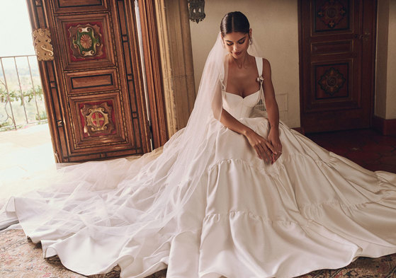 woman in wedding dress and veil sat on the floor under all the tulle layers