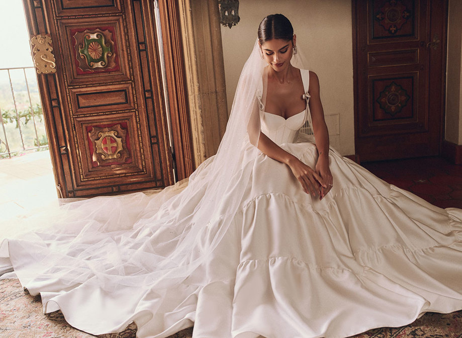 woman in wedding dress and veil sat on the floor under all the tulle layers