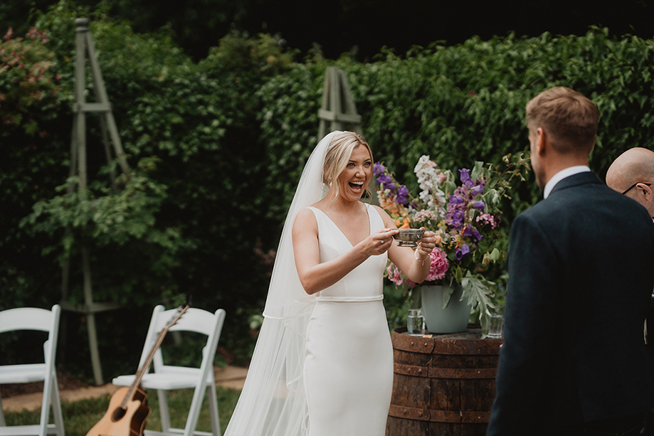 A Bride Laughing As She Drinks From A Silver Quaich