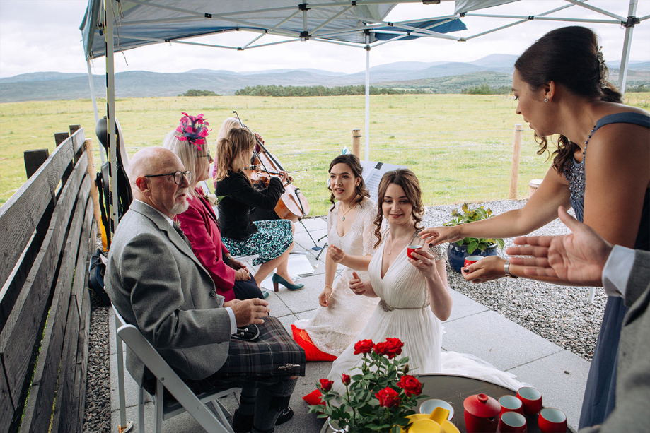 Two Brides Kneeling Performing A Chinese Tea Ceremony