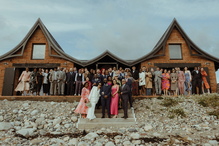 A Wedding Group Portrait Outside Dougarie Boathouse