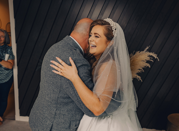 bride and man hugging and smiling