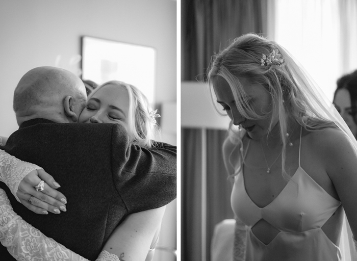 a close up black and white image of a bride hugging a bald man on left. A black and white image of a bride wearing a slip wedding dress and long pearl drop earrings looking downward