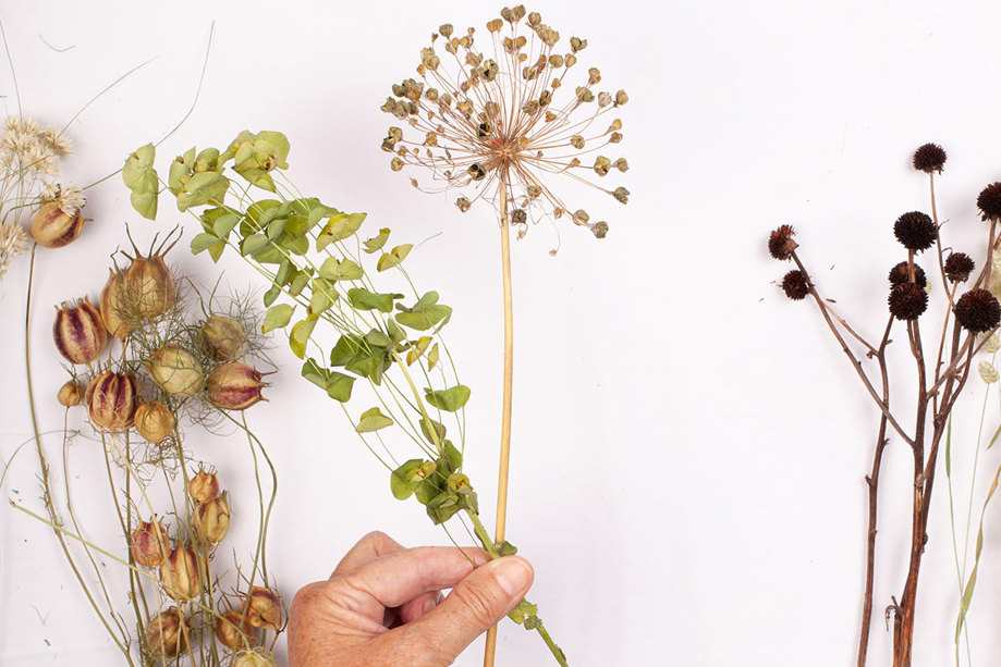 hand assembling dried flower bouquet - step two