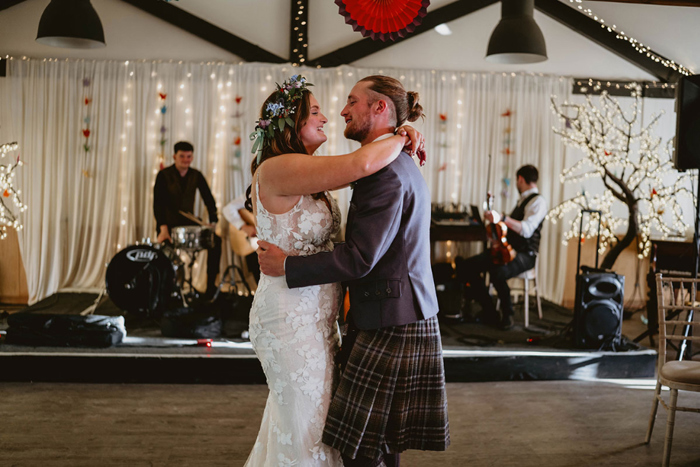 The bride and groom hug on the dancefloor