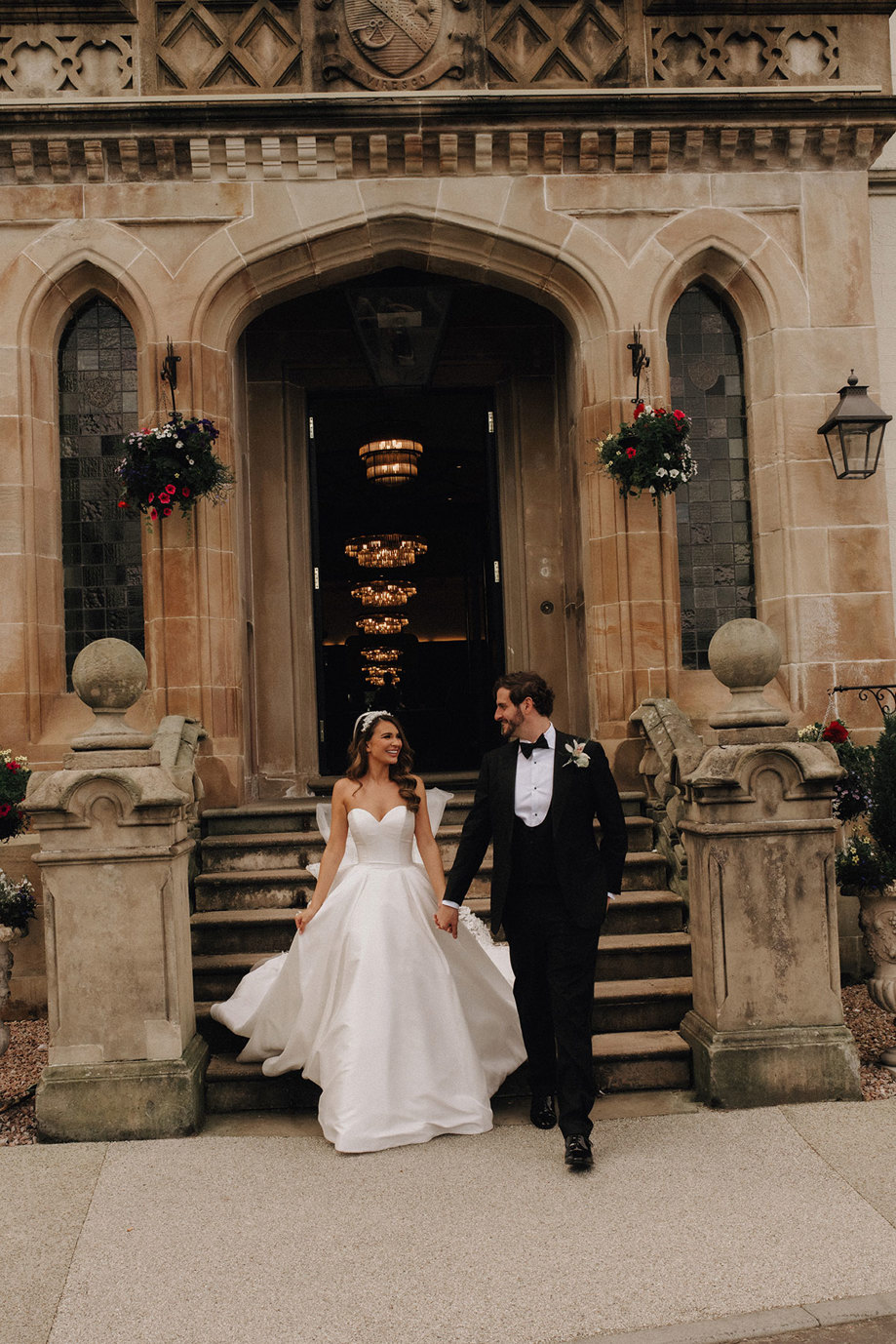 a bride and groom walking down stairs outside Cameron House.