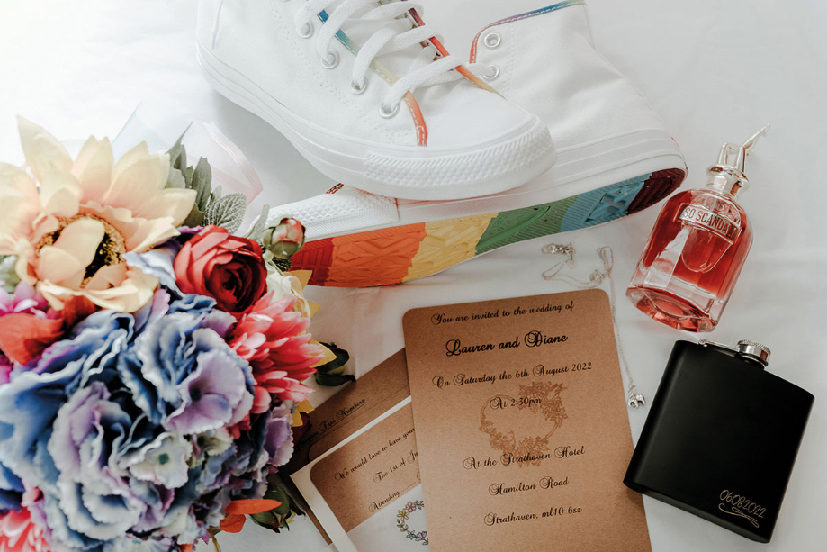 Wedding details including colourful Converse and flowers