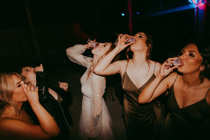 Bride and bridesmaids doing shots