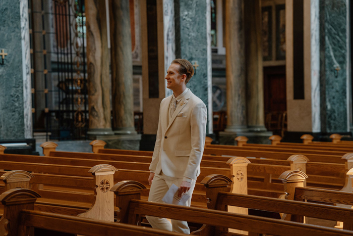 Groom walking down aisle of St Aloysius Church