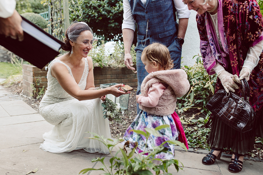 Toddler Daughter acting as Ring Bearer giving them to bride