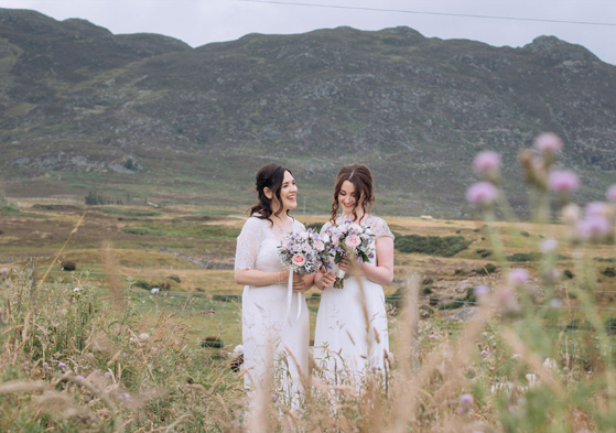 Two Brides Standing In Front Of Mountains In The Cairngorms National Park