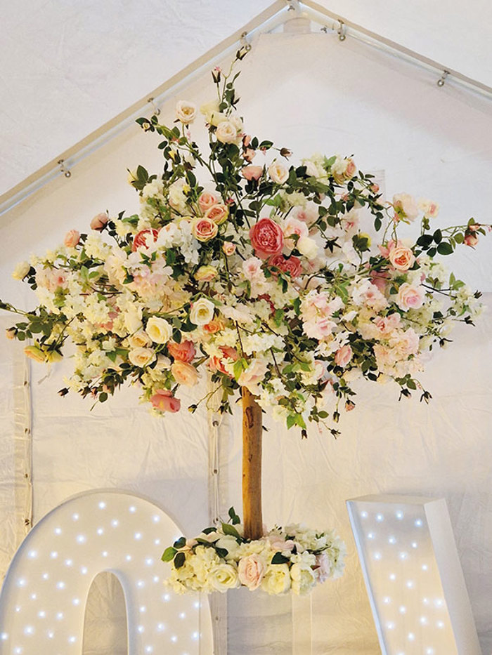 pastel floral tree displayed inside a marquee