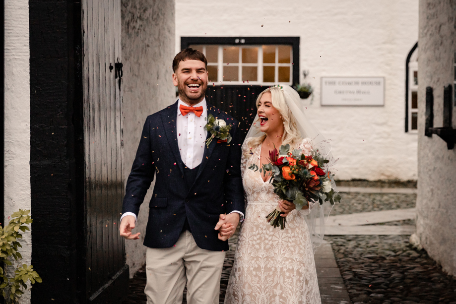 bride and groom laughing during wedding confetti shot at gretna green