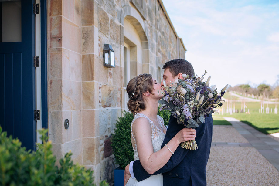 Bride and groom share a kiss