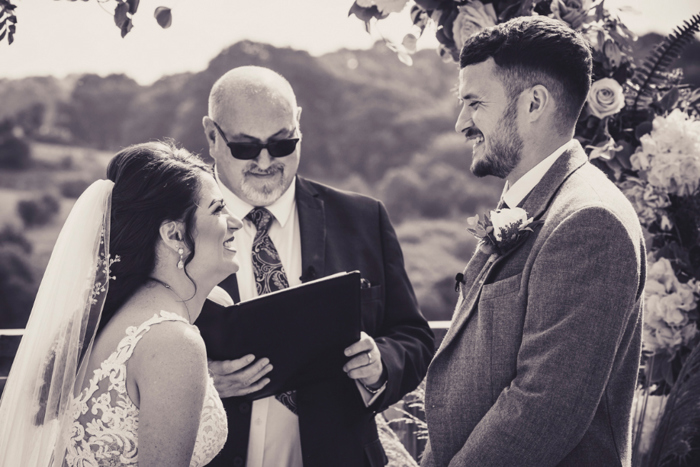 Bride and groom smile during the ceremony