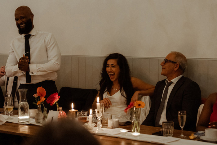 People Sitting At A Table Laughing At Dougarie Boathouse