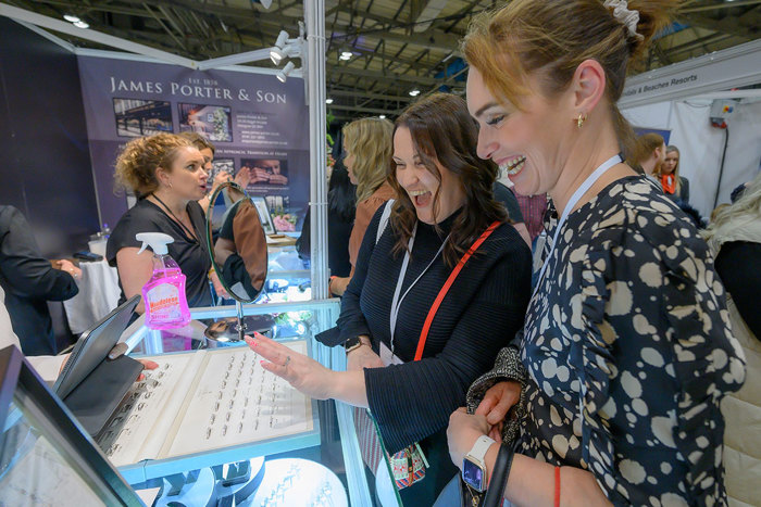 people looking at wedding rings on a stall at the Scottish Wedding Show