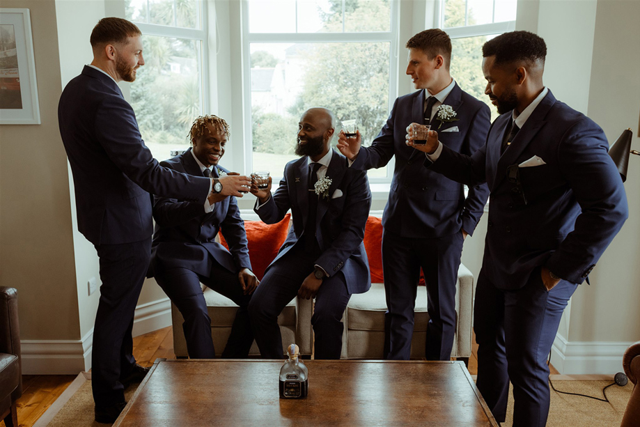 Five Men Wearing Navy Blue Suits Raising Glasses