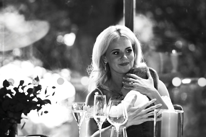 Black and white picture of bride holding small boy