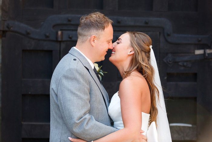 a bride and groom almost kissing 