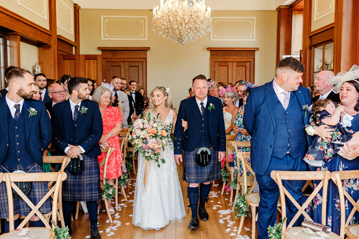 Bride walks down the aisle with her father