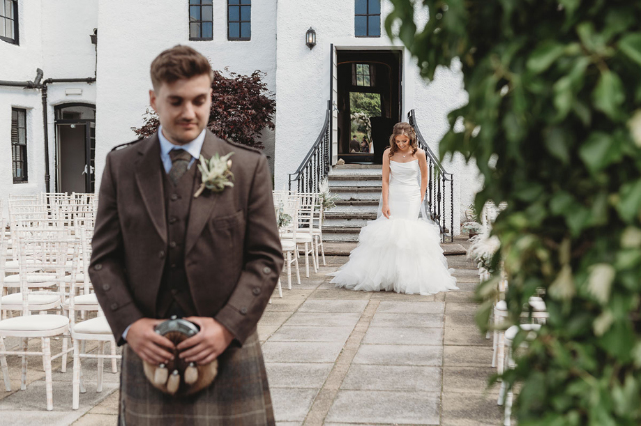 Bride walks towards groom for sweet first look 