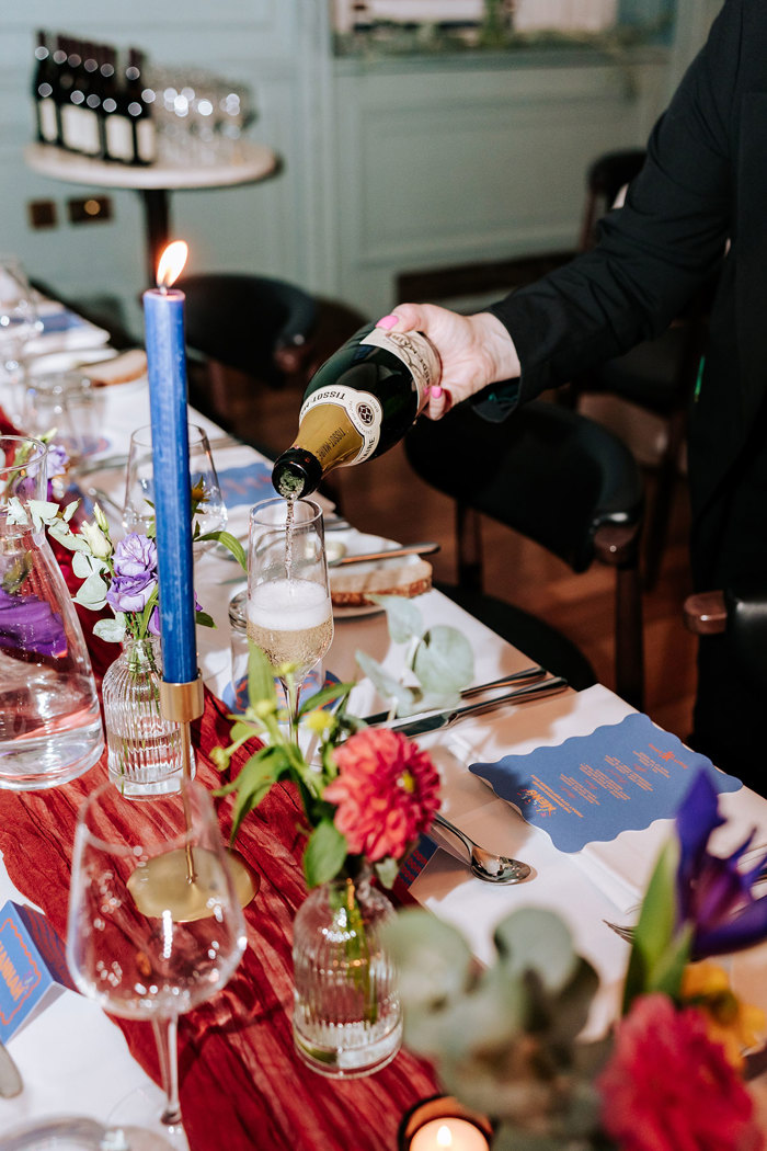 A person pouring champagne into a glass.