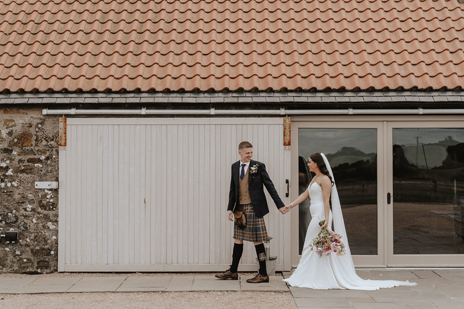 bride and groom walk around grounds at falside mill