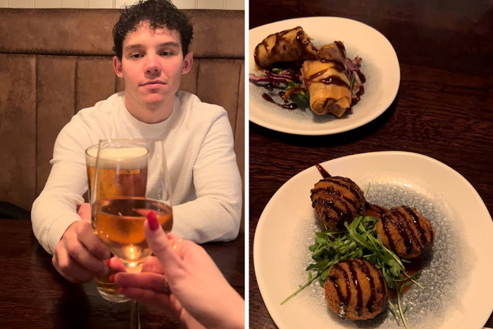 Girl and boy cheers with wine and beer glasses and two plates of starters