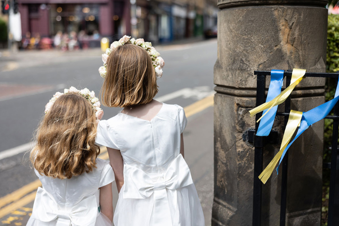 Flower girls watching for the wedding cars