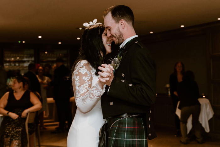 Couple hold hands during a dance