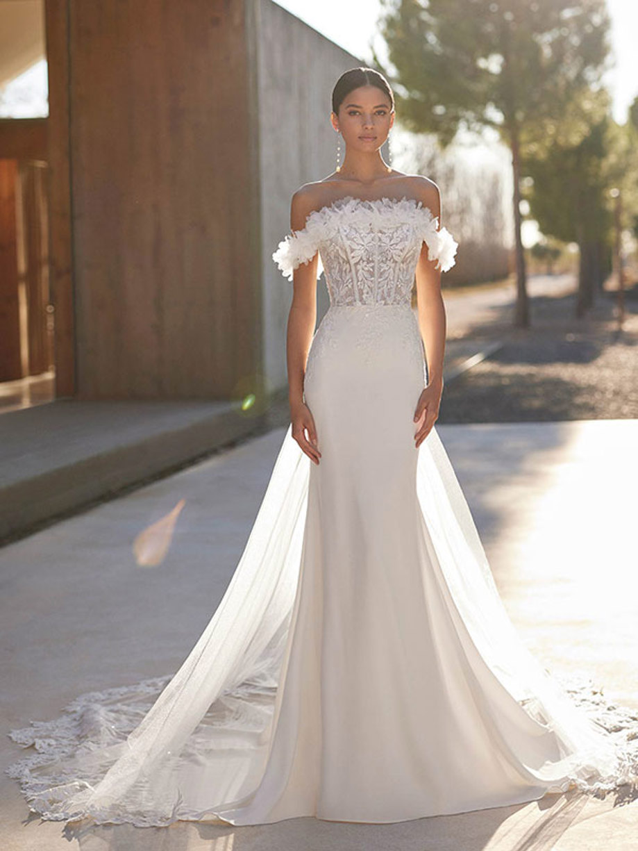 front facing model wearing shimmery off the shoulder wedding dress