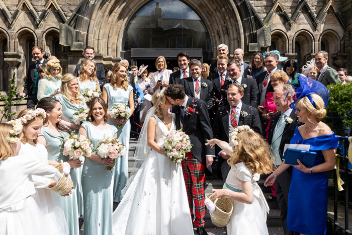 Bride and groom kiss outside church