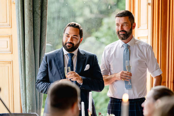 Grooms standing during wedding reception