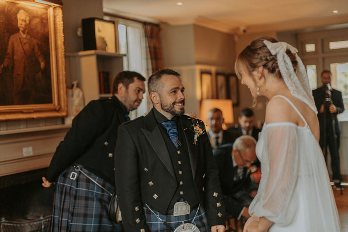 Bride and groom laugh during their wedding ceremony