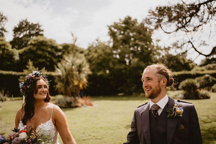 Bride looks at groom in outdoor couple portrait