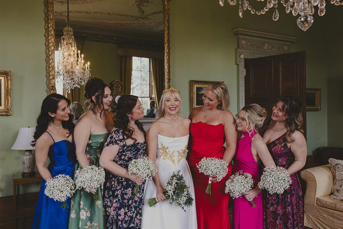 A group of women in dresses holding flowers