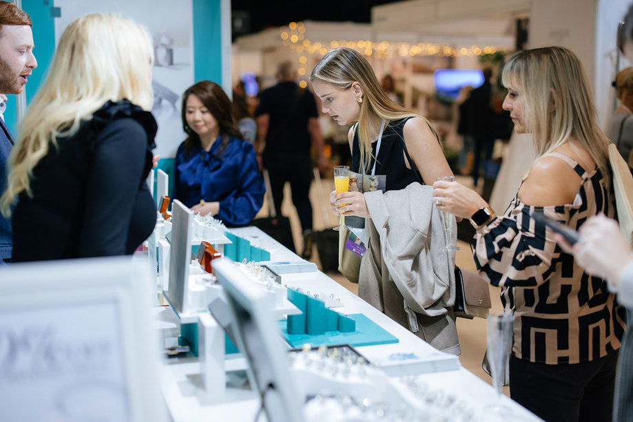 people browsing jewellery on a stand at an exhibition