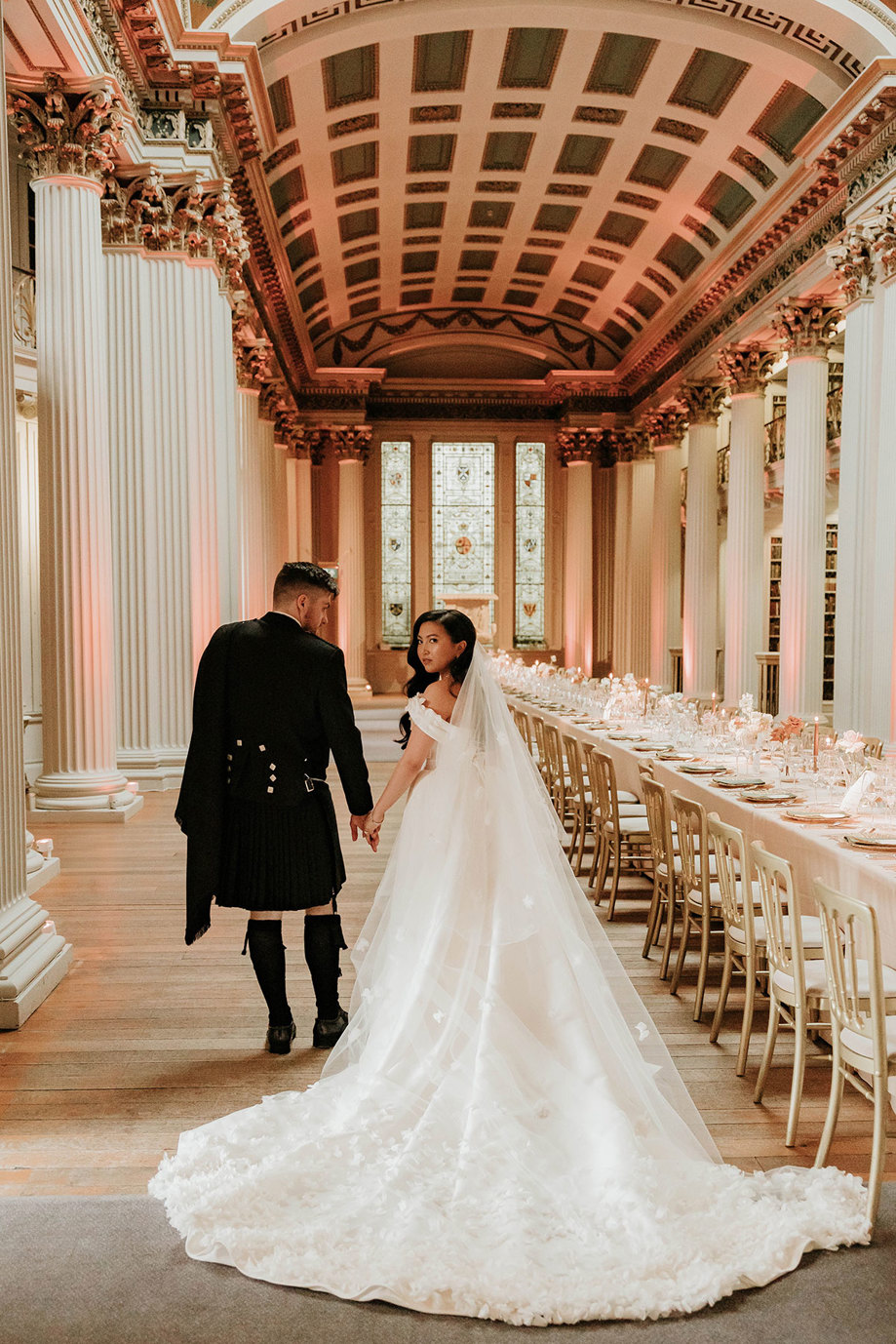 bride and groom walking through dinner room signet library edinburgh