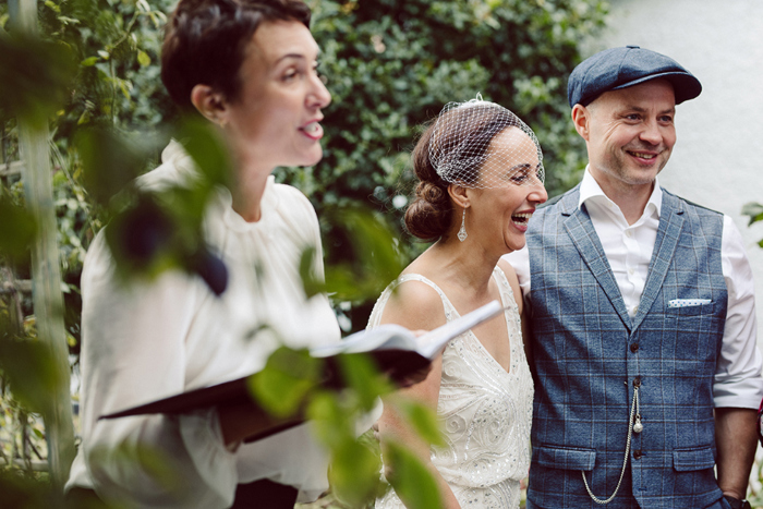 Bride and groom laugh during their wedding ceremony