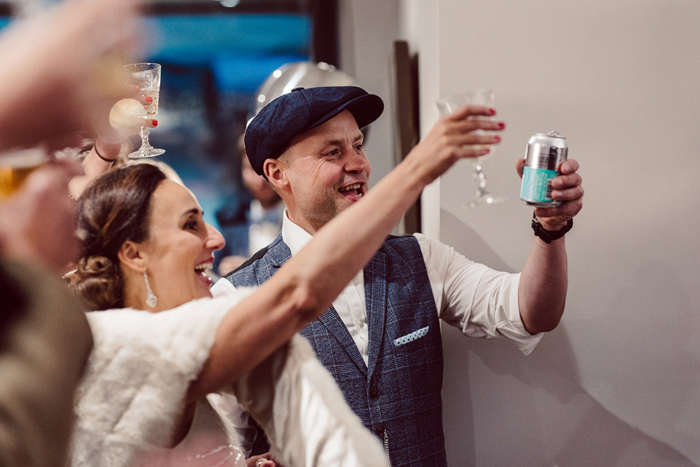 Bride and groom cheers during wedding speeches