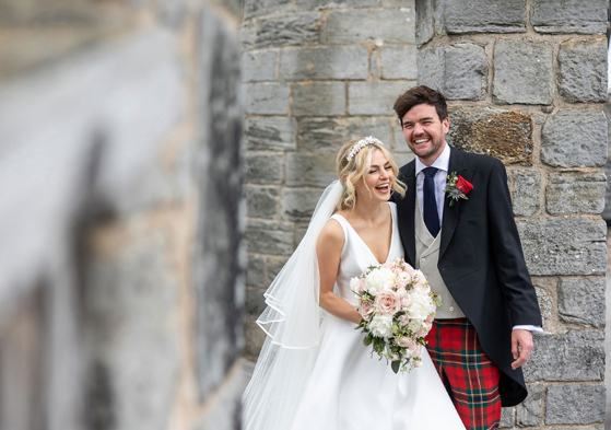 Bride and groom laugh during outdoor couple portraits