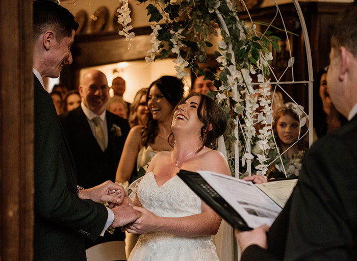 A bride laughing during the wedding ceremony