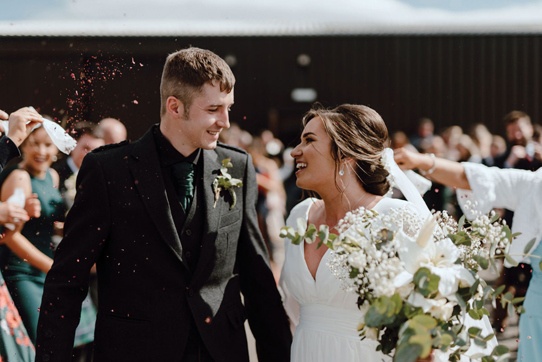 Bride and groom smile during couple portrait