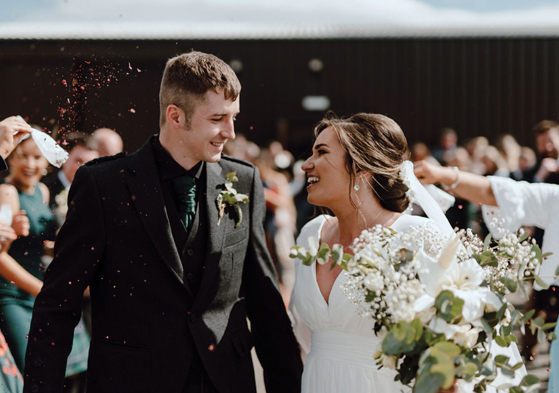 Bride and groom smile during couple portrait