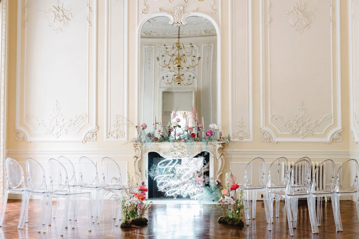 Wedding set up with foliage and neon sign at fireplace (Photo: fionakellyphotography.com)