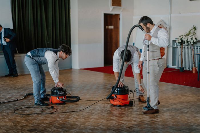 Guests hoovering up after wedding reception in Garnethill Multicultural Centre