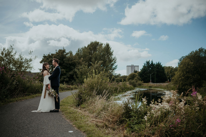 Couple pose on a path near water